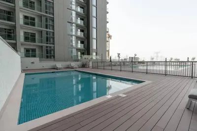 a swimming pool on a balcony of a building at Modern 1bdr - 10min from Burj Khalifa - Sobha Waves in Dubai