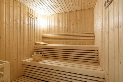 a wooden sauna with a bench in the middle at Modern 1bdr - 10min from Burj Khalifa - Sobha Waves in Dubai