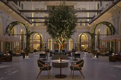 a lobby with a table and chairs and a tree at Vida Creek Beach Hotel in Dubai