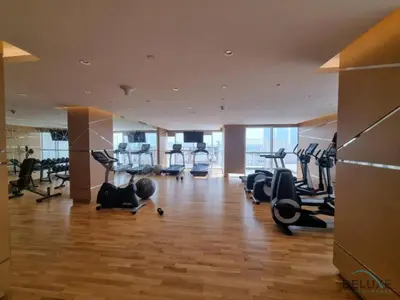 a gym with treadmills and cardio equipment in a building at Opulent Studio at Carson C DAMAC Hills Dubailand by Deluxe Holiday Homes in Dubai