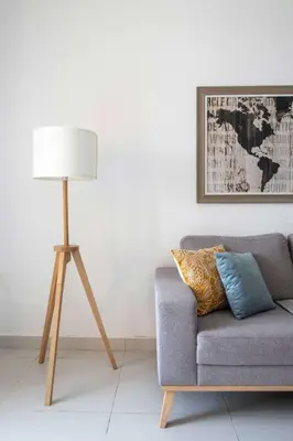 a lamp sitting next to a couch in a living room at Frank Porter - Palm Views East in Dubai