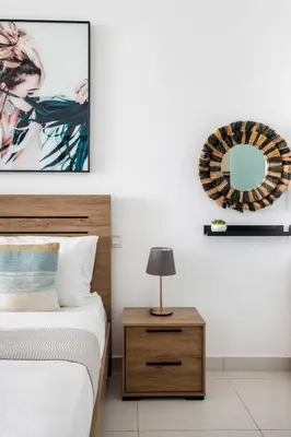 a bedroom with a bed and a mirror on the wall at Frank Porter - Palm Views East in Dubai