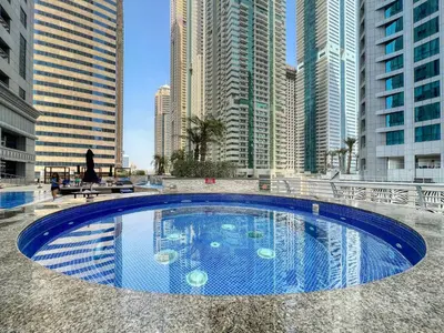 a swimming pool in the middle of a city with tall buildings at The Smart Concierge - Princess tower in Dubai