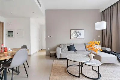 a living room with a couch and a table at Silkhaus new 1BDR in Executive Residence 2 in Dubai