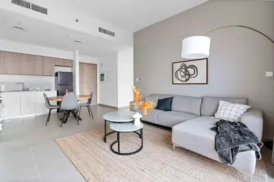 a living room with a couch and a table at Silkhaus new 1BDR in Executive Residence 2 in Dubai