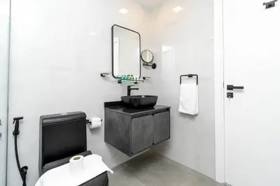 a bathroom with a black sink and a mirror at Central 1bdr - Al Quoz - Al Khail Height in Dubai