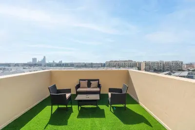 a balcony with chairs and a table on a roof at Central 1bdr - Al Quoz - Al Khail Height in Dubai