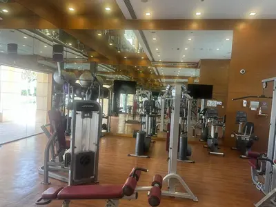 a gym with many cardio equipment in a room at Studio with Boulevard View in Dubai