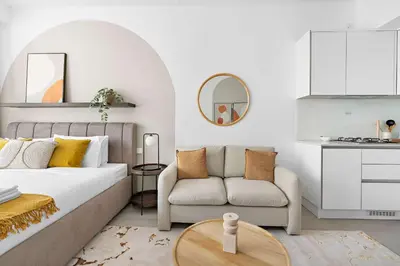a bedroom with a bed and a couch and a table at Silkhaus new studio in JVC with queen Bed in Dubai