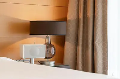 a bedroom with a bed with a lamp and a tv at Fashion Avenue Dubai Mall in Dubai