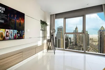 a living room with a view of a city at Luxe 2BR with Burj Khalifa View & Infinity Pool in Dubai