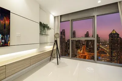 a room with a window with a view of a city at Luxe 2BR with Burj Khalifa View & Infinity Pool in Dubai