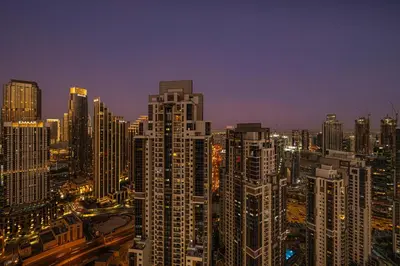 a city skyline at night with tall buildings at Luxe 2BR with Burj Khalifa View & Infinity Pool in Dubai
