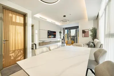 a conference room with a large white table and chairs at Luxe 2BR with Burj Khalifa View & Infinity Pool in Dubai
