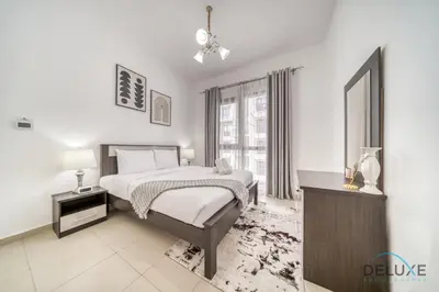 a white bedroom with a bed and a window at Soothing 1BR at Safi 1B Town Square Dubailand by Deluxe Holiday Homes in Dubai