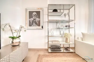 a living room with a couch and a table at Luxurious 4BR Penthouse with Assistant Room and a Sweeping Balcony Showcasing Burj Khalifa and Sea Views, Le Pont, La Mer by Deluxe Holiday Homes in Dubai