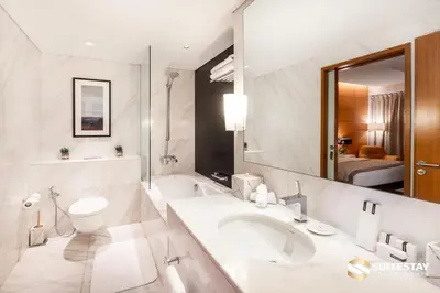 a bathroom with a sink and a toilet and a mirror at Fashion avenue Dubai Mall -The Residence in Dubai