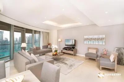 a living room with a couch and a tv at Fashion avenue Dubai Mall -The Residence in Dubai