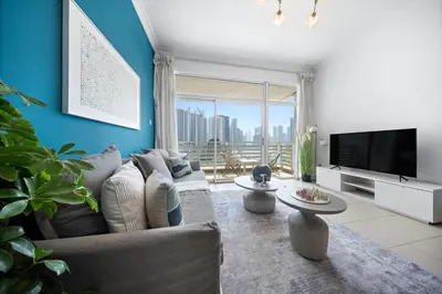 a living room with a couch and a flat screen tv at 1Br Suit with Full Canal View - Down Town in Dubai