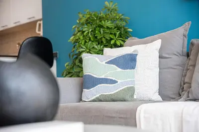 a couch with pillows on it in a living room at 1Br Suit with Full Canal View - Down Town in Dubai