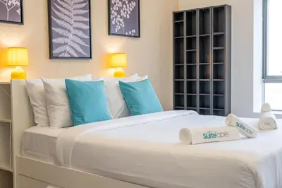 a bedroom with a large white bed with blue pillows at Hidden Gem 1 Bedroom apt in Dubai Sport City in Dubai