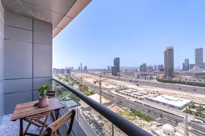 a balcony with a table and a view of a city at Hidden Gem 1 Bedroom apt in Dubai Sport City in Dubai