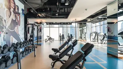 a gym with a lot of cardio equipment at Marina Gate One Bedroom Apartment in Dubai