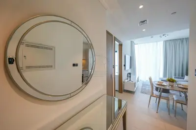 a large mirror on a wall in a room at Bright Apartment With Panoramic CityScape Views in Dubai