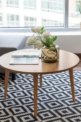 a coffee table with a vase of flowers on it at Frank Porter - Bonaire Tower in Dubai
