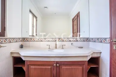 a bathroom with a sink and a mirror at Staycae Palm Jumeirah Villa in Dubai