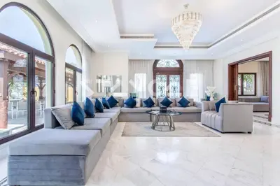 a living room with a large couch and blue pillows at Staycae Palm Jumeirah Villa in Dubai