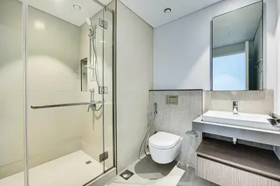 a bathroom with a shower and a toilet and a sink at Fantastic 2BD apartment in Dubai Creek Harbour in Dubai