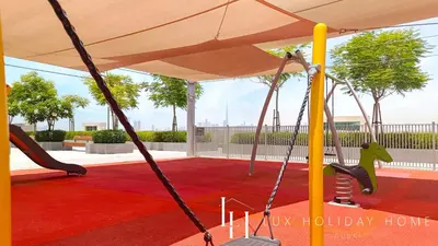 a swing set in a playground at LUX The Dubai Creek View Suite in Dubai
