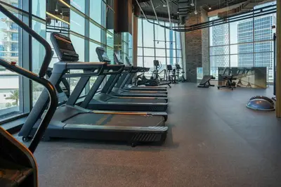 a gym with rows of treadmills and machines at Studio in heart of Dubai - 15 Northside - Business Bay in Dubai