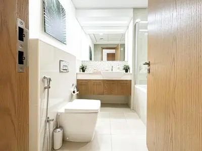 a bathroom with a toilet and a sink at Trophy - Downtown Skyline Sanctuary Suite in Dubai