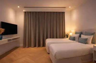 a hotel room with two beds and a television at Private villa in Dubai with swimming pool and huge garden in Dubai