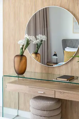 a mirror on top of a desk with two vases at Frank Porter - Creekside 18 in Dubai