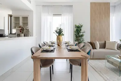 a living room with a wooden table and a couch at Frank Porter - Creekside 18 in Dubai