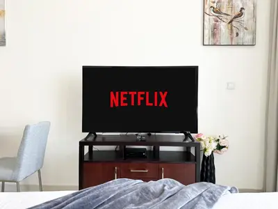 a television on a tv stand in a bedroom at Trophy - Urban Escape Suite in Dubai