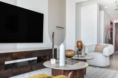 a living room with a tv and a couch at The Smart Concierge - Burjvista in Dubai