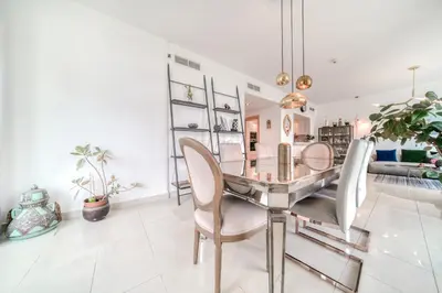a dining room with a glass table and chairs at Fairfield Tower, Park Island, Dubai Marina - Mint Stay in Dubai