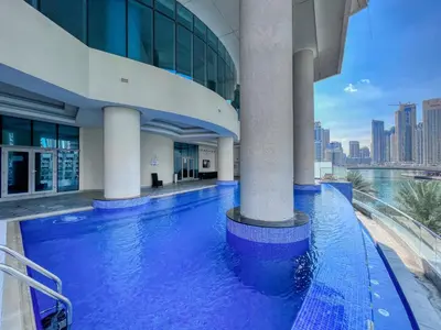 a swimming pool in the middle of a building at The Smart Concierge - Marinascape Oceanic in Dubai