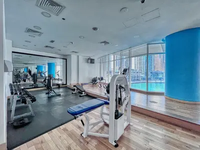 a gym with treadmills and exercise equipment in a building at The Smart Concierge - Marinascape Oceanic in Dubai