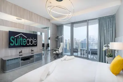 a bedroom with a white bed and a large window at Luxurious 3BR Apartment with Panoramic Marina View in Dubai