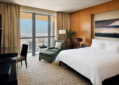 a hotel room with a large bed and a chair at Emaar Dubai Mall Residences - formerly Address Dubai Mall Residences - Burj Khalifa View in Dubai
