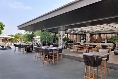 an outdoor patio with tables and chairs and a restaurant at Emaar Dubai Mall Residences - formerly Address Dubai Mall Residences - Burj Khalifa View in Dubai