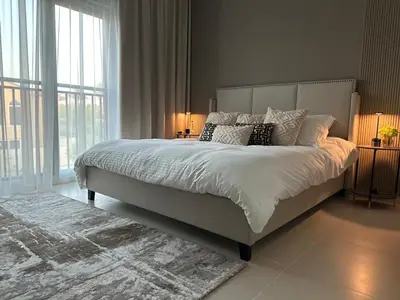 a bedroom with a large bed with white sheets and pillows at Luxurious 3BR Villa Amaranta in Dubai