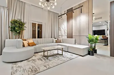 a living room with a white couch and a table at Luxurious 3BR Villa Amaranta in Dubai