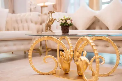 a living room with a table with a gold statue on it at Elite Royal Apartment - Full Burj Khalifa & Fountain View - Highness in Dubai