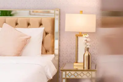 a bedroom with a bed and a table with a lamp at Elite Royal Apartment - Full Burj Khalifa & Fountain View - Highness in Dubai